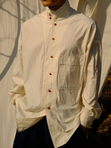 White shirt with a tailored stand collar and reversible lapel